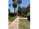 Well-maintained walkway with lush landscaping and tall palm trees at 4701 N 68Th St # 105, Scottsdale, AZ 85251