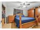 Comfortable bedroom features wood furniture, a ceiling fan and window coverings at 4726 W Indian School Rd, Phoenix, AZ 85031