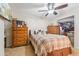 Cozy bedroom features wood furniture, a ceiling fan and closet at 4726 W Indian School Rd, Phoenix, AZ 85031