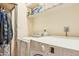 Functional laundry room with washer, dryer, and storage shelves for convenience at 4726 W Indian School Rd, Phoenix, AZ 85031