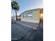 Charming manufactured home featuring a covered parking area and a desert-style landscaped front at 5601 W Missouri Ave # 63, Glendale, AZ 85301