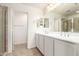 Bathroom boasts a double sink vanity, a large mirror, and a glass enclosed shower at 5812 W Illini St, Phoenix, AZ 85043