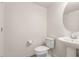 Powder room features a pedestal sink, toilet, and neutral decor at 5812 W Illini St, Phoenix, AZ 85043