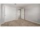 Bedroom with neutral walls, carpeted flooring, closet, and door to the bathroom at 5812 W Illini St, Phoenix, AZ 85043