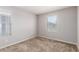 Bedroom offers carpeted flooring and natural light from two windows at 5812 W Illini St, Phoenix, AZ 85043