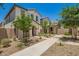 Charming two-story home with a red door, desert landscaping and a stone walkway at 5812 W Illini St, Phoenix, AZ 85043