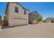 Street view of beige and gray home exterior featuring garages at 5812 W Illini St, Phoenix, AZ 85043