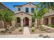 Charming two-story home with a red door, desert landscaping and an arched front entryway at 5812 W Illini St, Phoenix, AZ 85043