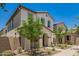 Charming two-story home with a red door, desert landscaping and an arched front entryway at 5812 W Illini St, Phoenix, AZ 85043