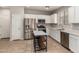 Bright kitchen features stainless appliances, a center island with breakfast bar, and white cabinets at 5812 W Illini St, Phoenix, AZ 85043
