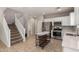 Open concept kitchen with stainless steel appliances, white cabinets, and a kitchen island at 5812 W Illini St, Phoenix, AZ 85043