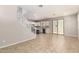Open concept living room with tile floors, a staircase, and sliding glass doors at 5812 W Illini St, Phoenix, AZ 85043