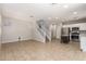 Open concept living room with tile floors, a staircase, and open kitchen at 5812 W Illini St, Phoenix, AZ 85043