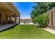 Large yard with green artificial turf and mature landscaping surrounding the property at 7031 W Lone Tree Trl, Peoria, AZ 85383