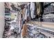 Walk-in closet with an abundance of clothes hanging on a metal rod at 7031 W Lone Tree Trl, Peoria, AZ 85383