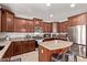 Granite countertops and stainless steel appliances in the kitchen with a center island at 7031 W Lone Tree Trl, Peoria, AZ 85383