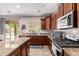 Spacious kitchen with stainless steel appliances, island, and sliding doors to backyard at 7031 W Lone Tree Trl, Peoria, AZ 85383