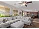 Comfortable living room with a large sectional sofa that opens to kitchen and dining at 7031 W Lone Tree Trl, Peoria, AZ 85383