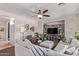 Relaxing living room space with a large sectional sofa, armchair and decorative shelving at 7031 W Lone Tree Trl, Peoria, AZ 85383