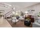 Spacious living room with high ceilings, a staircase, modern decor, and natural light at 7031 W Lone Tree Trl, Peoria, AZ 85383