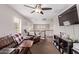 Living room with comfy couch, ceiling fan and view of the stairway at 7031 W Lone Tree Trl, Peoria, AZ 85383