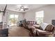 Living room with ceiling fan, comfy couch, desk and mountain view at 7031 W Lone Tree Trl, Peoria, AZ 85383