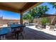 Covered patio with outdoor dining area overlooking the pool and water feature at 7031 W Lone Tree Trl, Peoria, AZ 85383