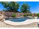 Backyard pool with stone accents and well-maintained landscaping at 7031 W Lone Tree Trl, Peoria, AZ 85383