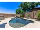Beautiful backyard pool with rock waterfall and lush landscaping at 7031 W Lone Tree Trl, Peoria, AZ 85383