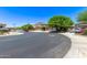A curved street reveals an attractive community with well-maintained homes and desert landscaping at 7031 W Lone Tree Trl, Peoria, AZ 85383