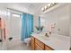 Bright bathroom with wood cabinets, and a shower/tub at 7526 W Cheryl Dr, Peoria, AZ 85345