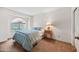 Bright bedroom featuring a bed, nightstand, and arched window at 7526 W Cheryl Dr, Peoria, AZ 85345