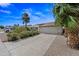 Well-maintained home with desert landscaping, a two-car garage, and long driveway at 7526 W Cheryl Dr, Peoria, AZ 85345