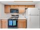 Bright kitchen with white countertops, wood cabinets, and modern appliances including a gas range at 7526 W Cheryl Dr, Peoria, AZ 85345