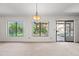 Bright living room with neutral carpet and large windows overlooking the landscaped backyard and patio at 7526 W Cheryl Dr, Peoria, AZ 85345