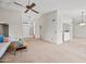 Open-concept living room with vaulted ceiling, ceiling fan, and neutral paint colors at 7526 W Cheryl Dr, Peoria, AZ 85345