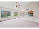 Spacious living room with views of the kitchen and backyard featuring plush neutral carpet and lots of light at 7526 W Cheryl Dr, Peoria, AZ 85345