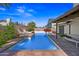 Inviting pool area featuring a sparkling pool and brick-laid patio with flowers at 7526 W Cheryl Dr, Peoria, AZ 85345