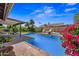 A refreshing backyard pool with lush landscaping, covered patio, and outdoor seating area at 7526 W Cheryl Dr, Peoria, AZ 85345
