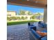 Beautiful backyard features a well-manicured lawn, a paver patio, lounge seating and a view of neighboring houses at 7925 S 24Th Way, Phoenix, AZ 85042