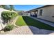 Spacious backyard with artificial lawn, mature landscaping, a paver patio and partial mountain views at 7925 S 24Th Way, Phoenix, AZ 85042