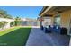 This backyard features a covered patio area, an artificial lawn, and a block wall for privacy at 7925 S 24Th Way, Phoenix, AZ 85042