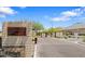 Attractive stone-clad community entrance sign with mature landscaping, leading to a gated entry at 7925 S 24Th Way, Phoenix, AZ 85042