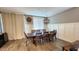 Elegant dining room featuring a large wooden table and chairs, and a stylish chandelier at 7925 S 24Th Way, Phoenix, AZ 85042