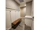 Inviting entryway featuring a practical bench with coat hooks, and stylish wood-look tile flooring at 7925 S 24Th Way, Phoenix, AZ 85042