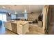Open kitchen with a large granite island, stainless steel appliances, and a view of the living area at 7925 S 24Th Way, Phoenix, AZ 85042