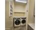 Convenient laundry room includes modern washer and dryer with built in storage space at 7925 S 24Th Way, Phoenix, AZ 85042