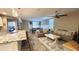 Open-concept living room with a kitchen island, a comfortable sofa, and a dining area at 7925 S 24Th Way, Phoenix, AZ 85042