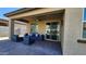 Relaxing covered patio with ample seating options, including a comfortable outdoor sofa and lounge chairs at 7925 S 24Th Way, Phoenix, AZ 85042