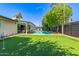 Stunning backyard featuring a pristine pool, putting green, and lush landscaping for ultimate relaxation at 8119 E San Miguel Ave, Scottsdale, AZ 85250